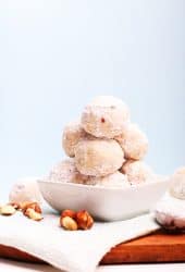 Stack of snowball cookies in a small white bowl