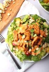 Finished salad on a white plate with a fork