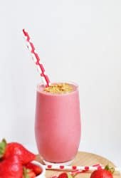 Finished smoothie in a large glass with a red straw