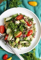 Mediterranean Quinoa Salad on a white plate with a fork