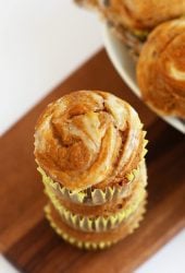 Stack of finished muffins on a wooden platter