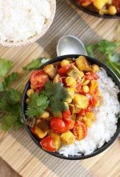 Finished dish served over rice in a small black bowl