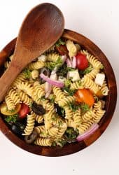 Finished salad in a wooden salad bowl with wooden spoon