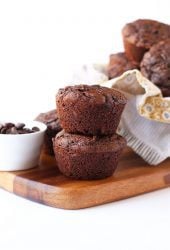 Two chocolate muffins on a wooden board