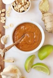 Finished sauce on a marble platter with limes and peanuts