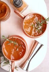 Moscow Mule recipe in a copper mug with rosemary.