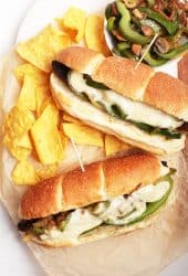 Vegan Philly Cheesecake sandwiches on platter with chips