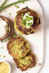 Stack of vegan zucchini fritters with sour cream