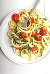 Zucchini noodle salad on white plate