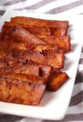 Strips of vegan bacon on a white plate