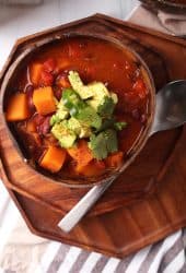 Bowl of finished chili with cilantro and avocado