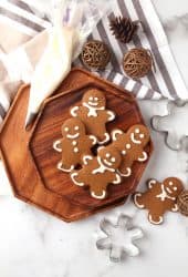 Finished gingerbread cookies on a wooden platter