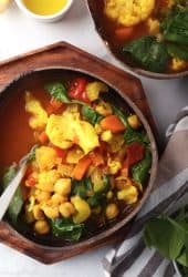 Bowl of vegetable soup in a coconut bowl