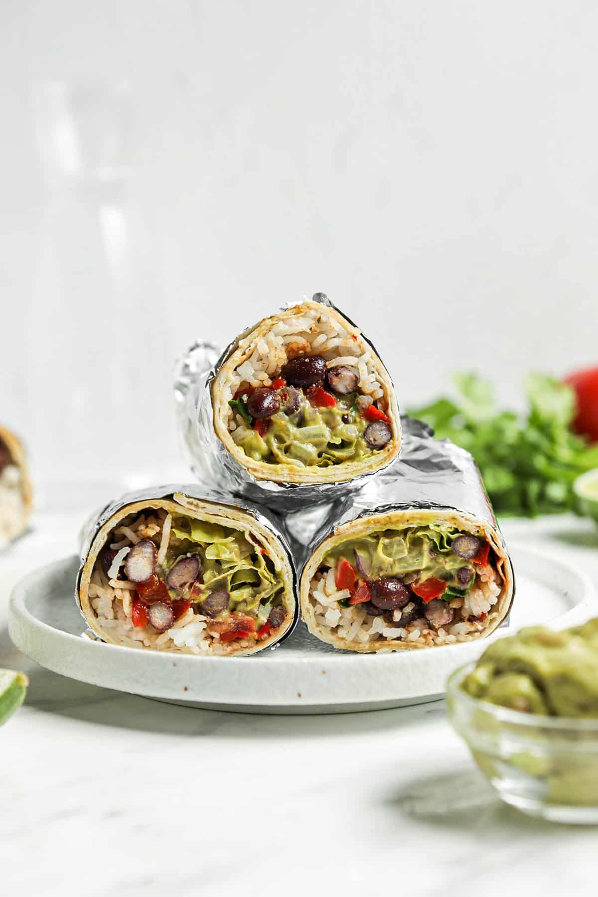 three burritos on white plate