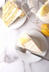 Two slices of lemon cake on white plates